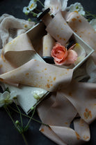 eco print silk ribbond for sustainable weddings. flatlay wedding photography featuring silk ribbon