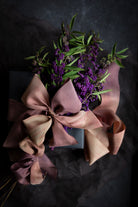 botanical inspired gift wrapping featuring black wrapping paper and purple flowers