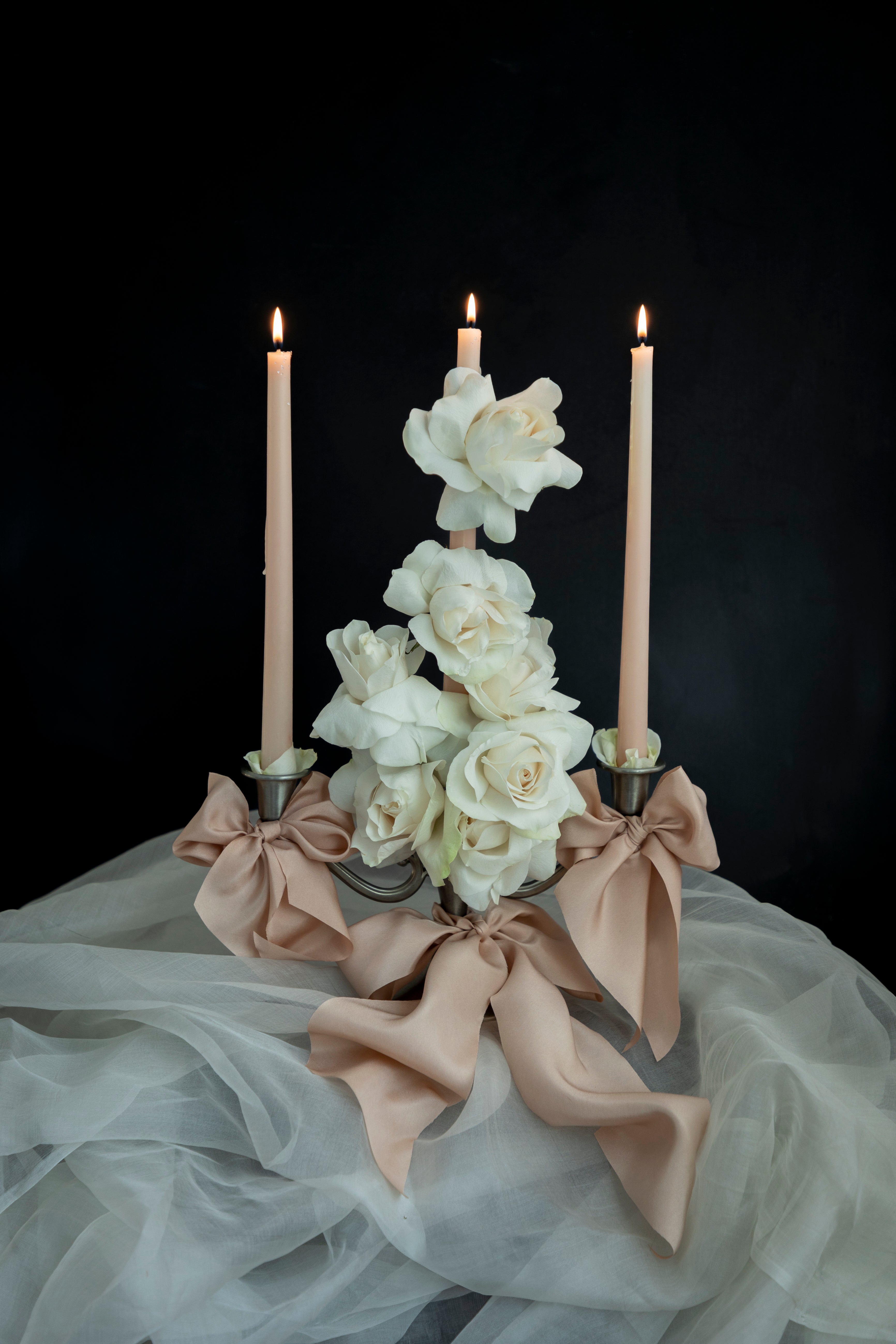 white roses, blush candles and blush silk ribbon candle centerpiece wedding trend ribbon bows