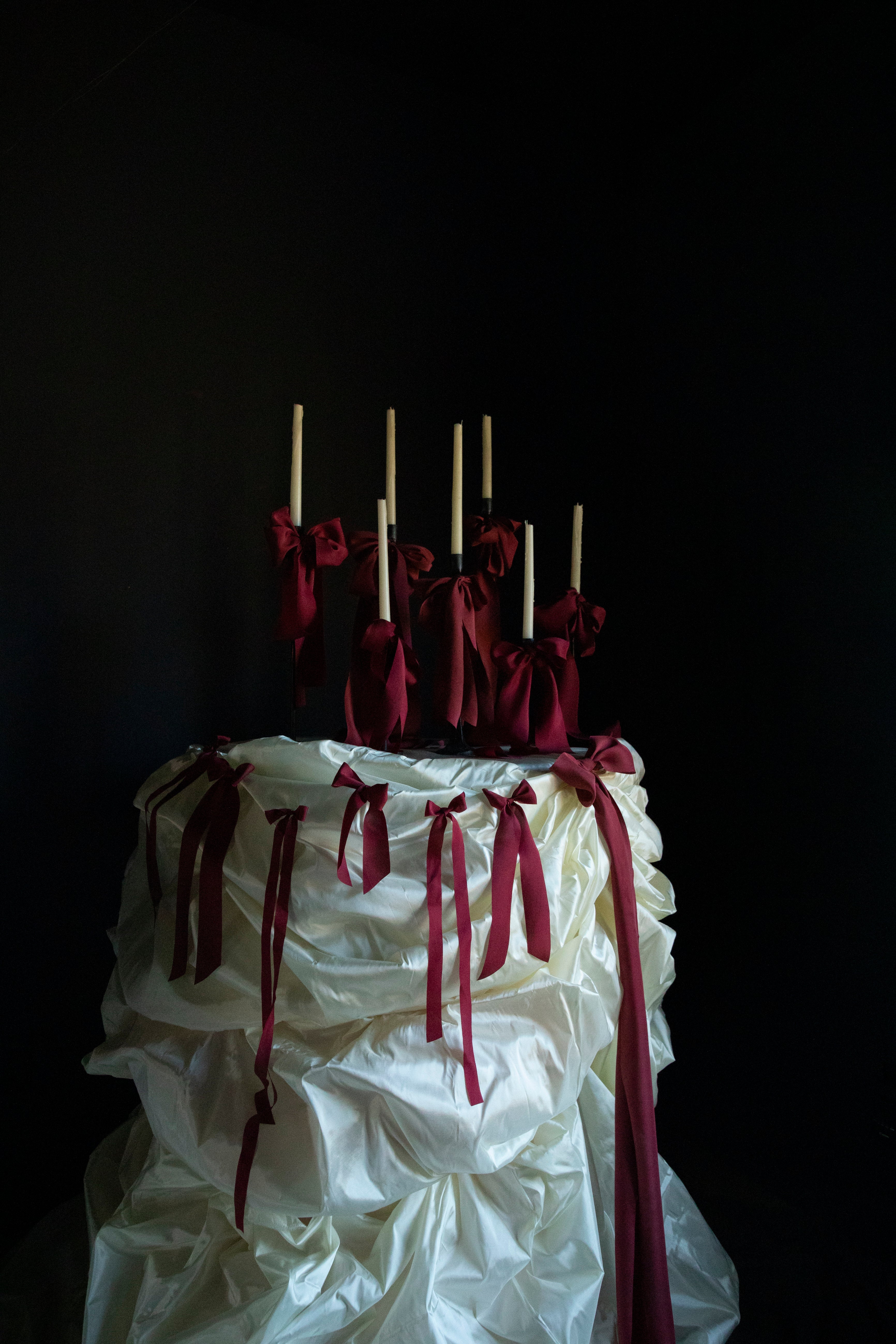 luxury wedding cake table with red ribbon bows