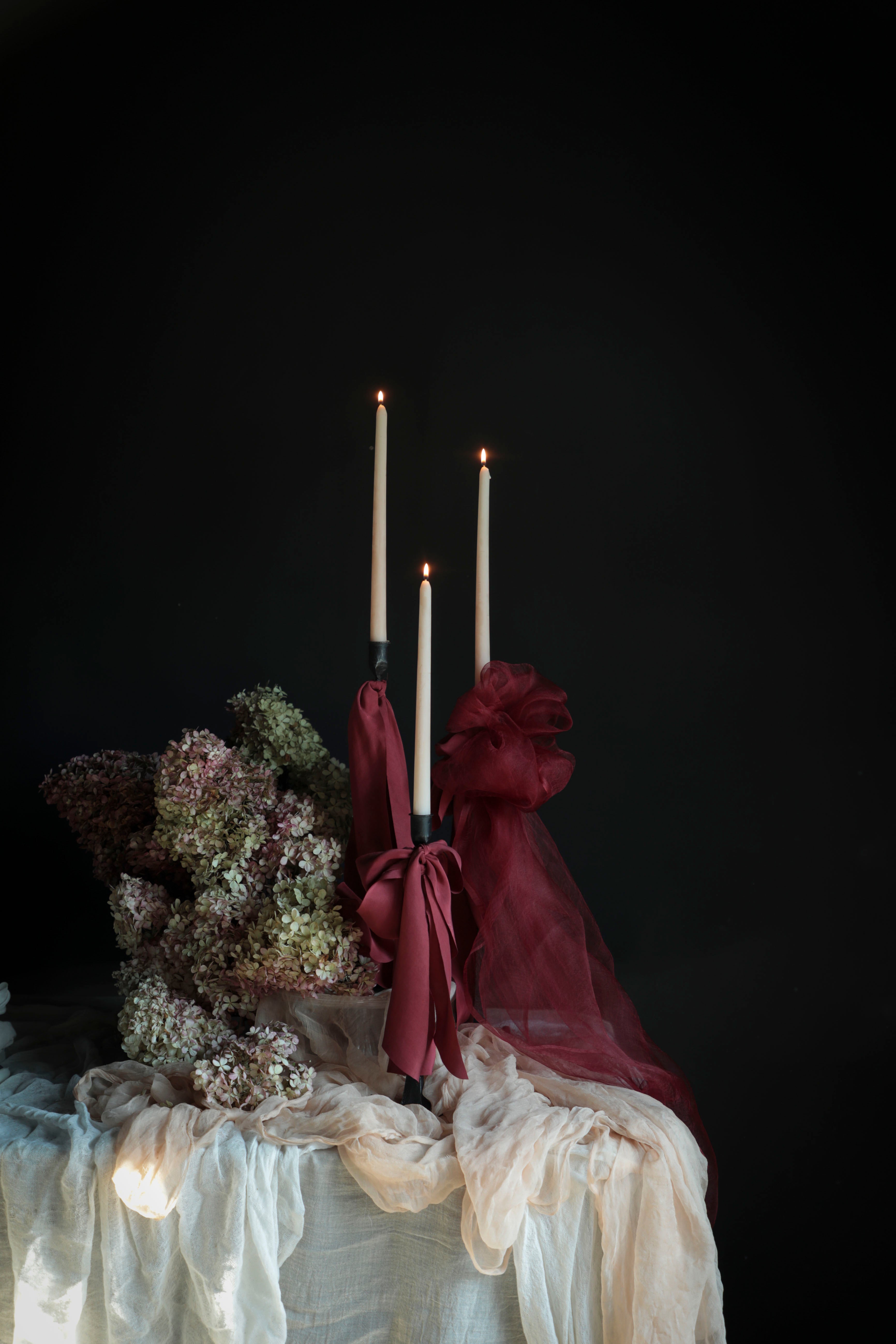 red wedding palette. red silk ribbon bows on candle display. wedding stylist silk and willow