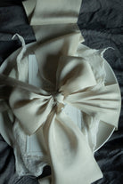 Ultra-luxe bridal bouquet silk ribbon showcasing its premium thickness and elegant drape, highlighting the highest quality silk ribbon on the market. ribbon tied on a tablescape place setting for bespoke wedding details.